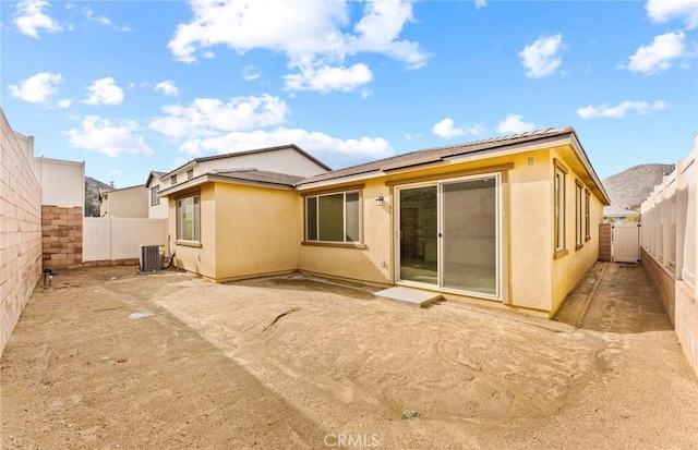 rear view of property featuring central air condition unit