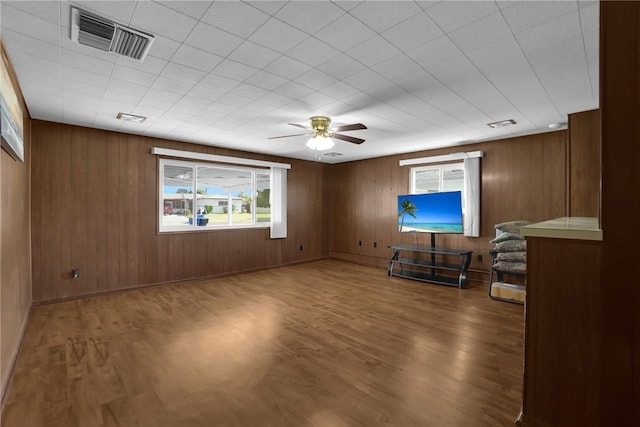 unfurnished living room featuring visible vents, ceiling fan, and wood finished floors