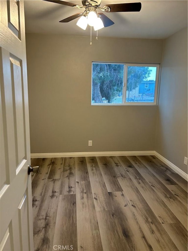 empty room featuring hardwood / wood-style flooring and ceiling fan