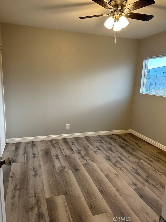 unfurnished room with ceiling fan and wood-type flooring