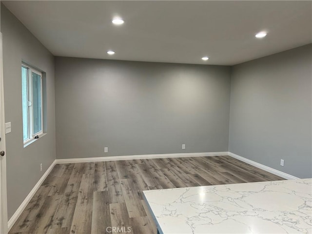 unfurnished room featuring hardwood / wood-style flooring