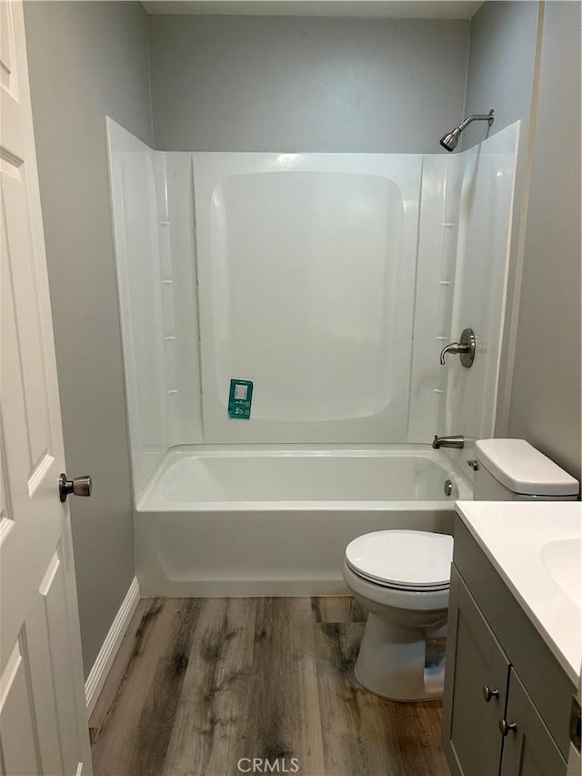 full bathroom featuring shower / tub combination, vanity, hardwood / wood-style flooring, and toilet