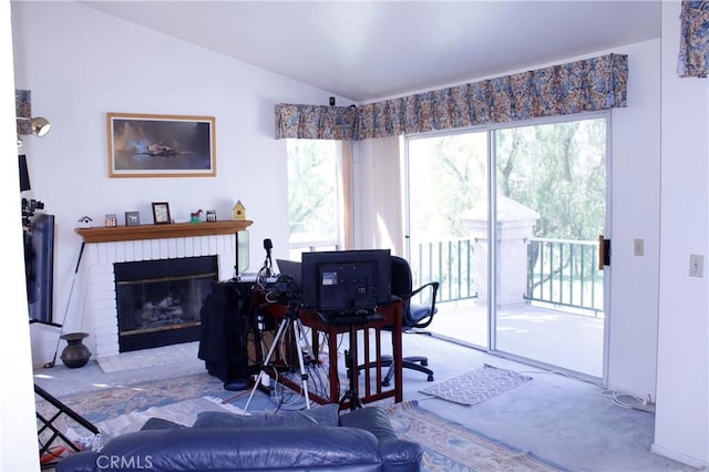 interior space featuring a brick fireplace and vaulted ceiling