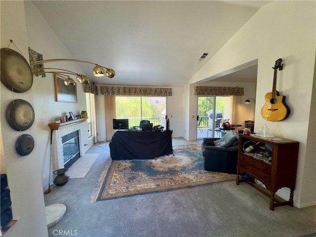 living room with lofted ceiling, carpet flooring, and a brick fireplace