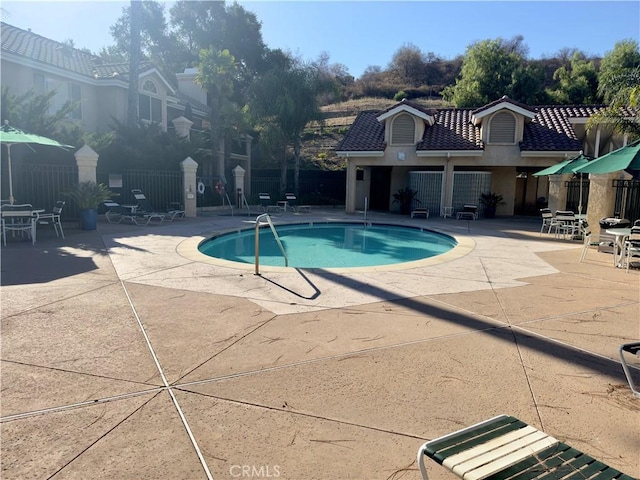 view of swimming pool with a patio area