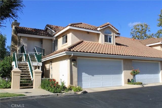 mediterranean / spanish-style home featuring a garage