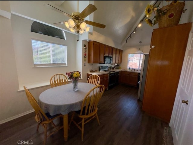 dining space featuring dark hardwood / wood-style flooring, lofted ceiling, and ceiling fan