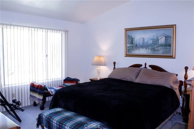 bedroom with vaulted ceiling and carpet