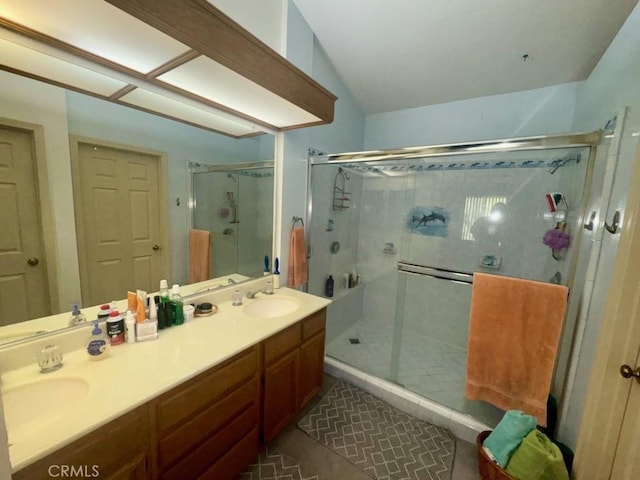 bathroom featuring vanity, a shower with door, and lofted ceiling