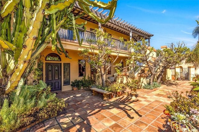 exterior space featuring french doors, a patio area, and a balcony