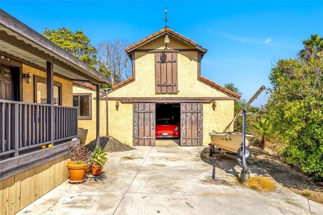 rear view of house with an outdoor structure