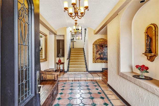 corridor with vaulted ceiling and a notable chandelier