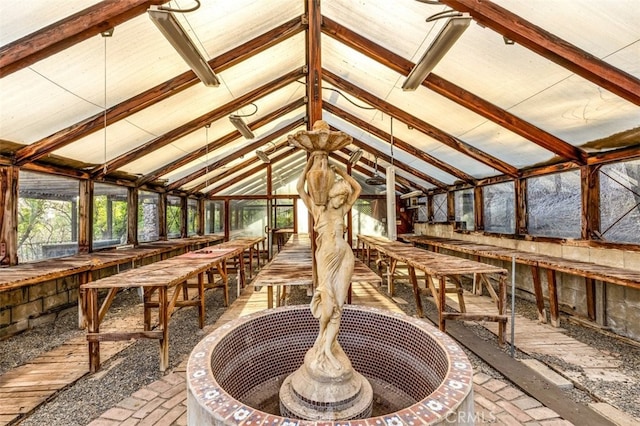 sunroom with vaulted ceiling with beams