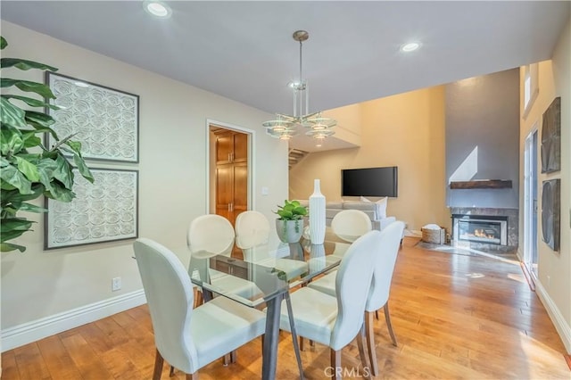 dining room featuring a fireplace and light hardwood / wood-style flooring