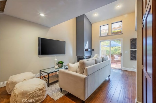 living room featuring hardwood / wood-style floors and a towering ceiling