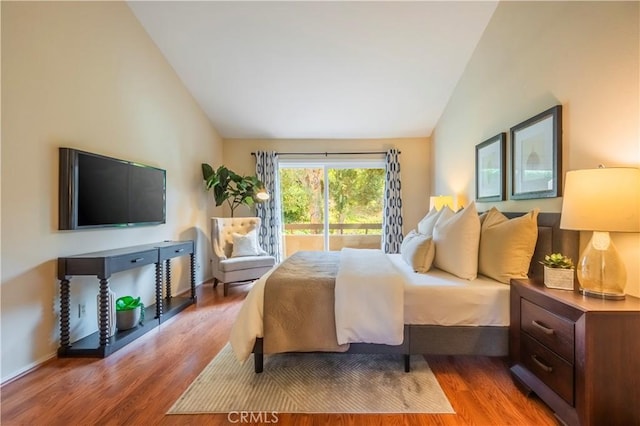 bedroom featuring hardwood / wood-style flooring and lofted ceiling