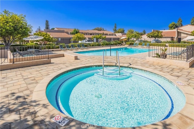 view of pool featuring a community hot tub and a patio