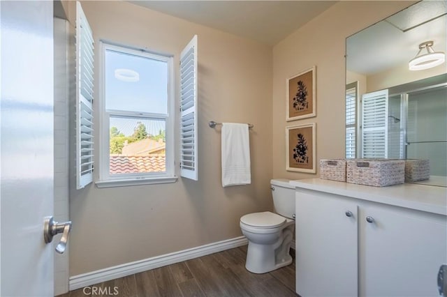 bathroom with hardwood / wood-style floors and toilet