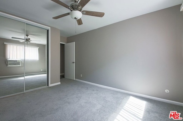 unfurnished bedroom with ceiling fan, cooling unit, a closet, and carpet flooring