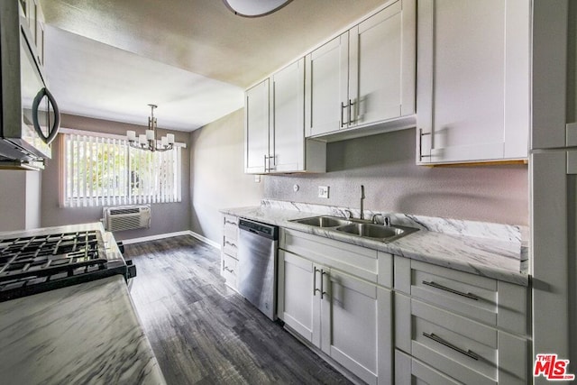 kitchen featuring sink, appliances with stainless steel finishes, dark hardwood / wood-style floors, light stone countertops, and an AC wall unit