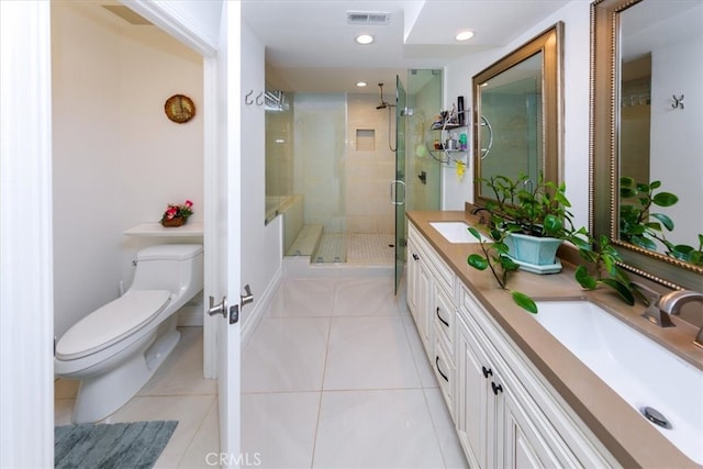 bathroom with vanity, toilet, tile patterned floors, and a shower with shower door