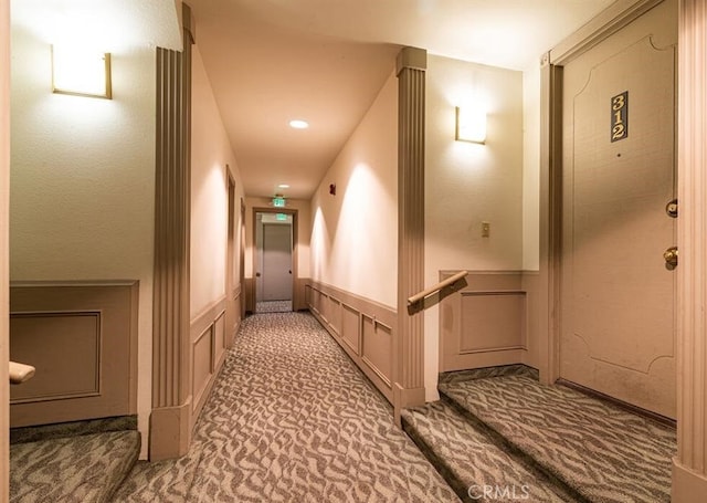 hallway with carpet floors