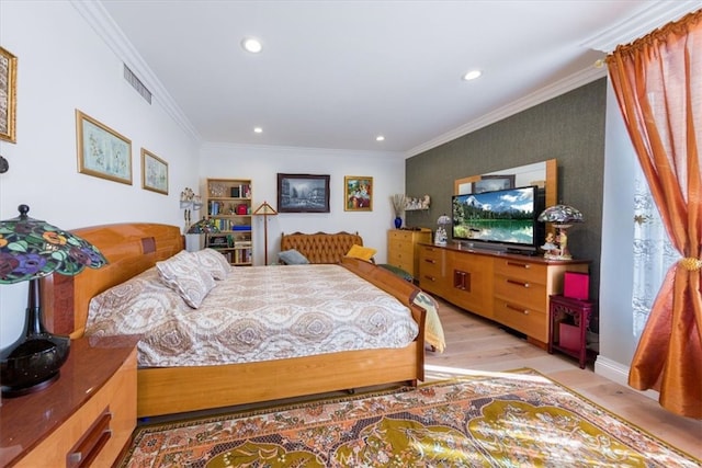 bedroom featuring light hardwood / wood-style flooring and crown molding