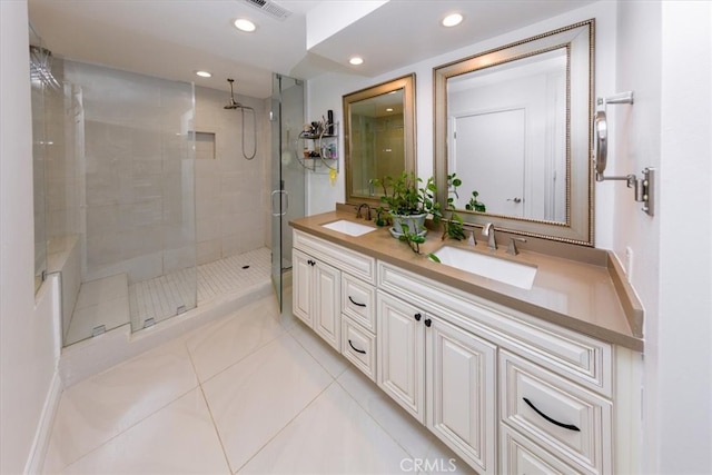 bathroom featuring tile patterned floors, an enclosed shower, and vanity