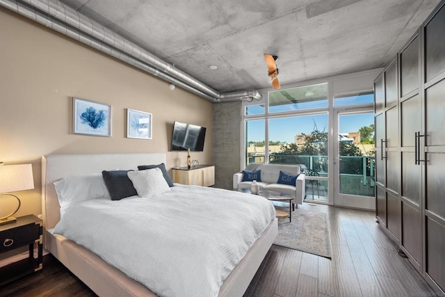 bedroom featuring access to outside and dark hardwood / wood-style flooring