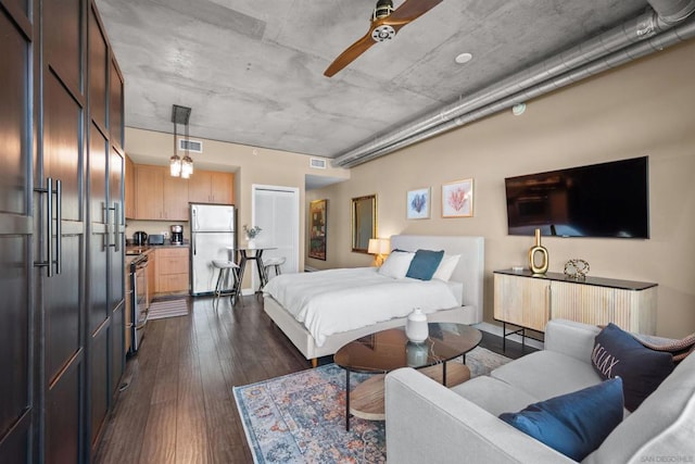 bedroom with ceiling fan, built in refrigerator, stainless steel refrigerator, and dark hardwood / wood-style floors