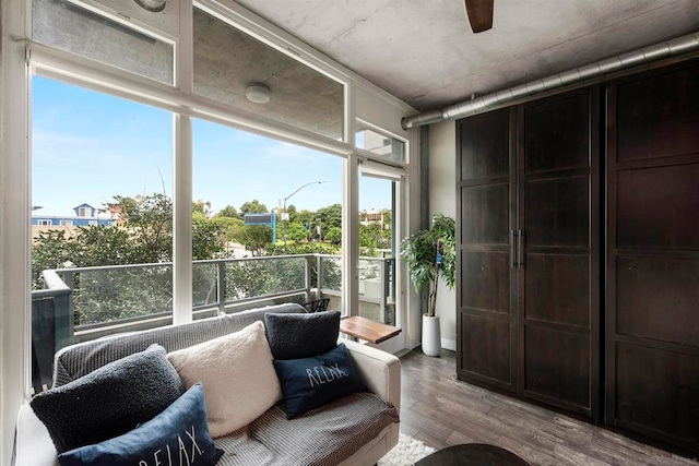 living room featuring light wood-type flooring, a healthy amount of sunlight, and ceiling fan