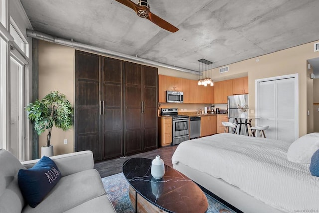 bedroom with ceiling fan, stainless steel refrigerator, and dark hardwood / wood-style flooring