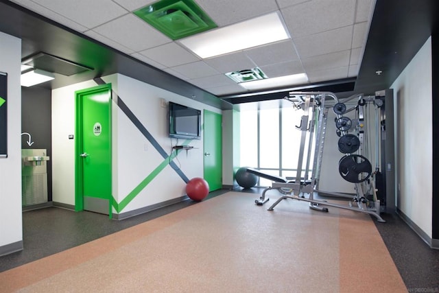 workout area featuring a paneled ceiling