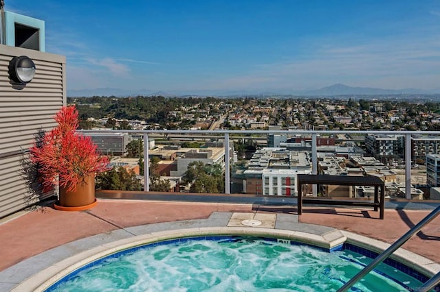 view of swimming pool with a community hot tub and a mountain view