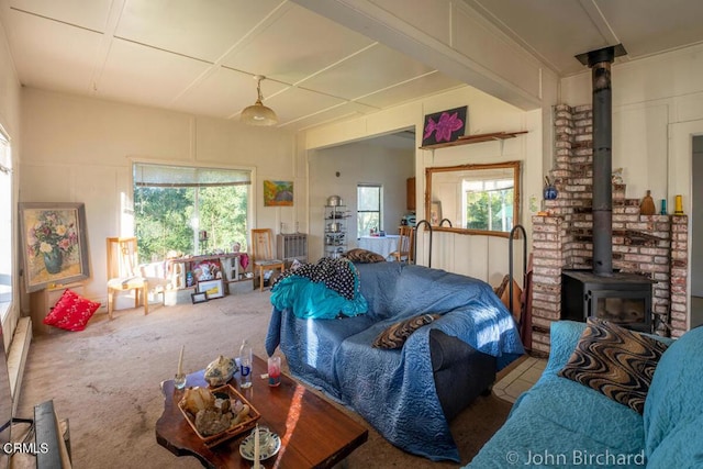 carpeted living area featuring a wood stove