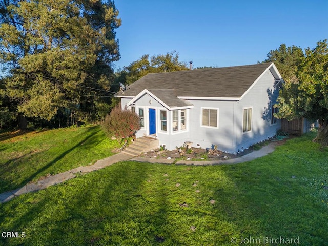 bungalow-style house with a front yard