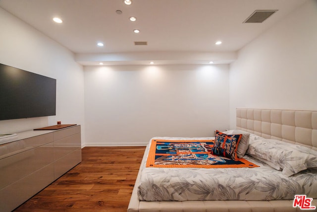 bedroom with dark hardwood / wood-style flooring