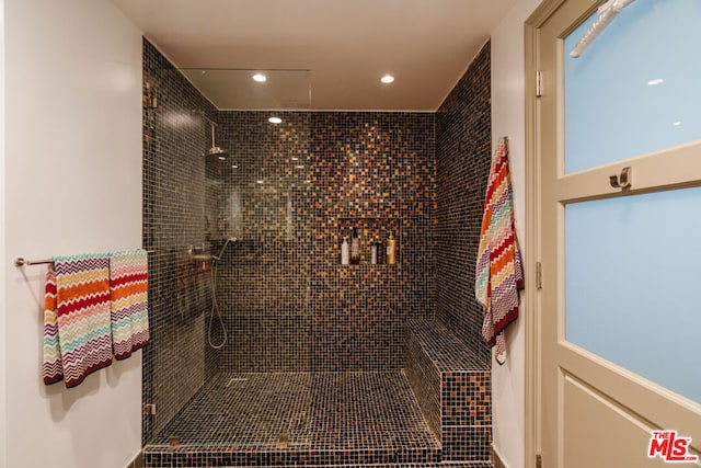 bathroom with a tile shower