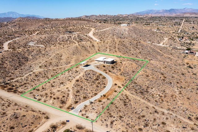 birds eye view of property with a mountain view