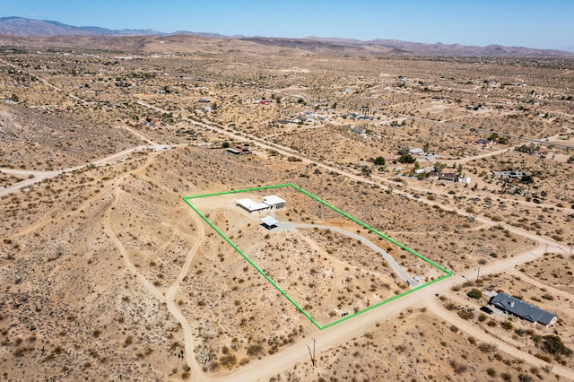 birds eye view of property with a mountain view