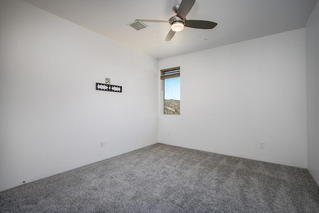 carpeted spare room with ceiling fan