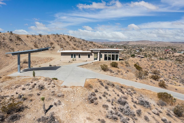 view of front of house with a mountain view and a patio area