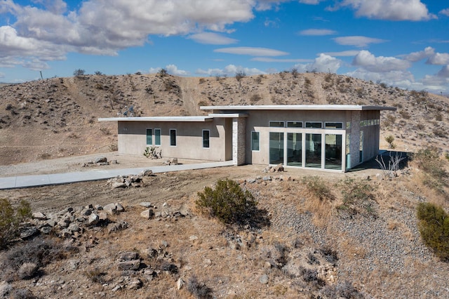 back of property featuring a mountain view