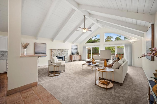 living room with a fireplace, vaulted ceiling with beams, and ceiling fan