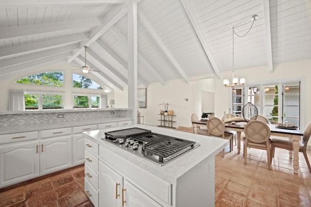 kitchen with pendant lighting, white cabinetry, stainless steel gas cooktop, and tasteful backsplash