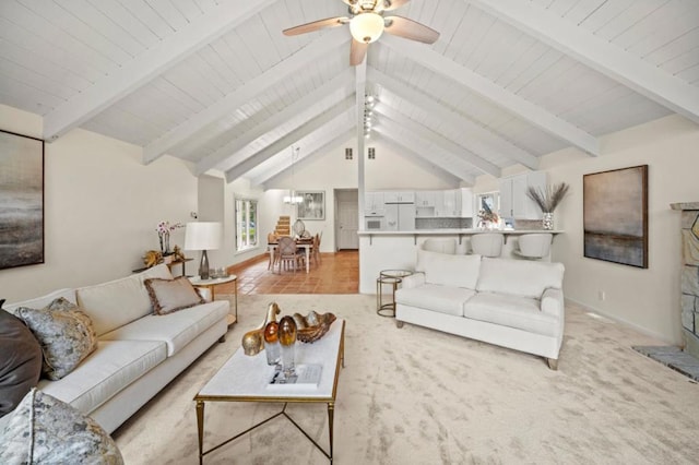 living room with ceiling fan, light parquet flooring, and lofted ceiling with beams