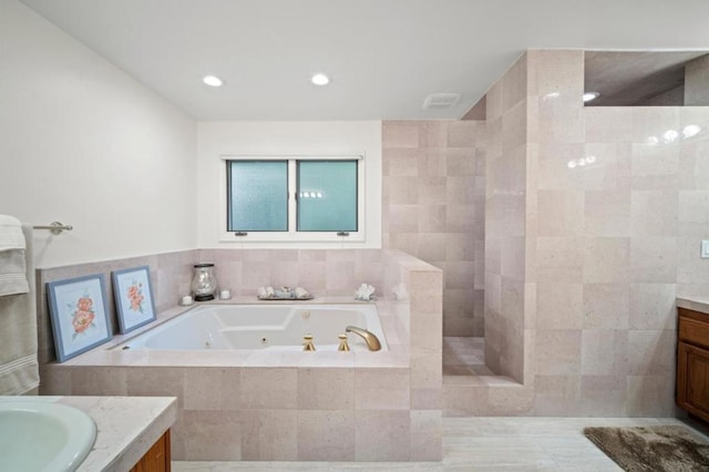 bathroom featuring shower with separate bathtub and vanity