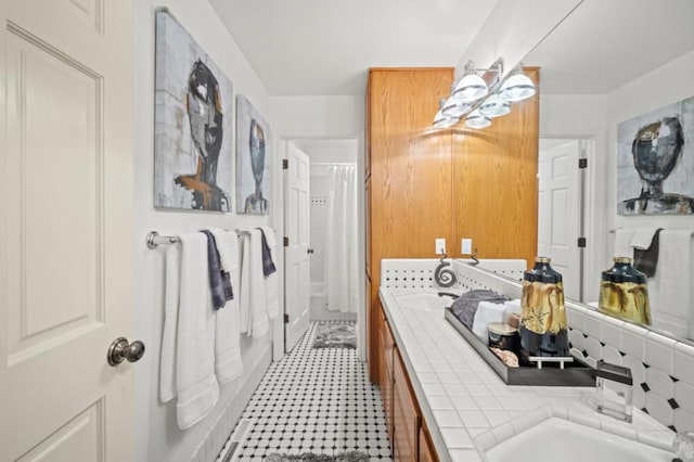 bathroom featuring tasteful backsplash, a bathtub, and vanity