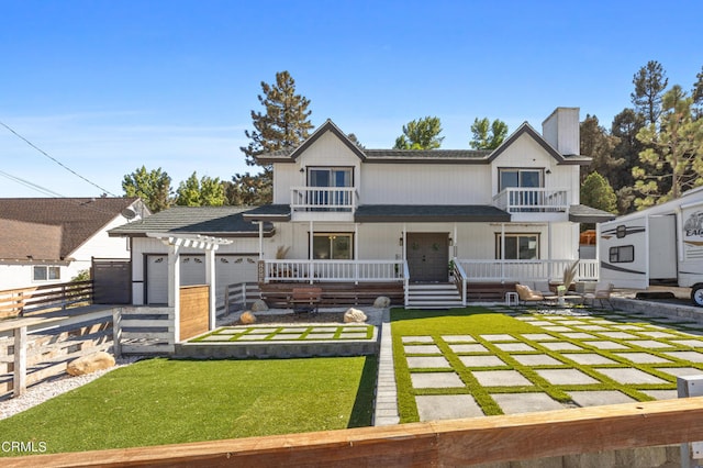 view of front facade featuring a front yard, a balcony, a pergola, and a patio