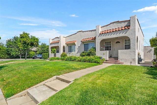 mediterranean / spanish home featuring a front yard